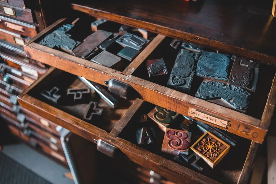 Vintage metal letterpress type stored in cabinet drawers